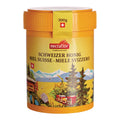 Gelber Honigbehälter mit oranger Deckel und Schweizer Alpenlandschaft sowie der Aufschrift 'nectaflor SCHWEIZER HONIG MIEL SUISSE - MIELE SVIZZERO'