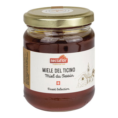 Glas mit goldfarbenem Deckel und Etikett mit der Aufschrift 'nectaflor Tradition seit 1958 MIELE DEL TICINO Miel du Tessin Finest Selection' und einer Zeichnung einer Kirche