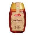 Honigflasche mit goldfarbenem Deckel und braunem Etikett mit der Aufschrift 'nectaflor BIO SCHWEIZER HONIG Miel Suisse' und einem Blumenmotiv
