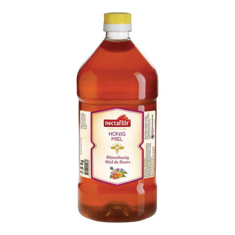 Große Plastikflasche mit gelbem Schraubverschluss und Etikett der Marke nectaflor mit der Aufschrift 'HONIG MIEL Blütenhonig Miel de fleurs'