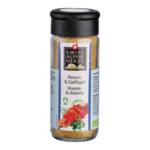 Transparente Gewürzmühle mit schwarzem Deckel. Auf dem Etikett steht „Fleisch & Geflügel / Viande & Volaille“ unter dem Swiss Alpine Herbs Logo. Im Glas ist eine gelblich-braune Gewürzmischung sichtbar. Unten sind Fleischspiesse mit Gemüse, grüne Kräuter sowie das Bio-Logo abgebildet.