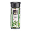 Transparente Gewürzmühle mit schwarzem Deckel. Auf dem Etikett steht „Petersilie / Persil“ unter dem Swiss Alpine Herbs Logo. Im Glas sind getrocknete grüne Kräuter sichtbar. Unten ist eine Abbildung von Petersilie sowie das Bio-Suisse-Logo zu sehen.