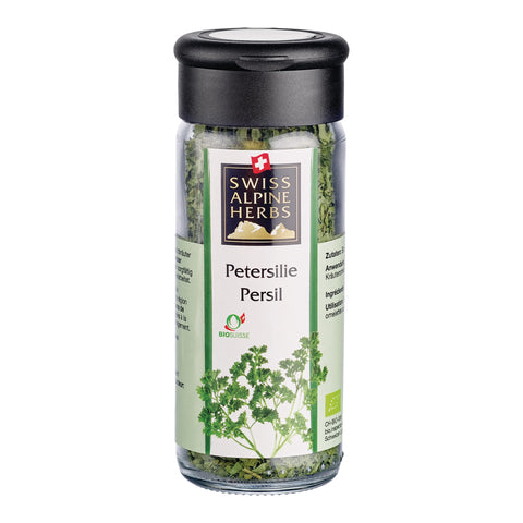 Transparente Gewürzmühle mit schwarzem Deckel. Auf dem Etikett steht „Petersilie / Persil“ unter dem Swiss Alpine Herbs Logo. Im Glas sind getrocknete grüne Kräuter sichtbar. Unten ist eine Abbildung von Petersilie sowie das Bio-Suisse-Logo zu sehen.