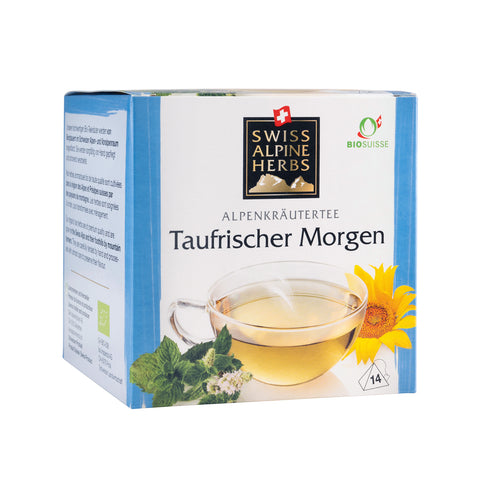 Verpackung von Swiss Alpine Herbs Alpenkräutertee 'Taufrischer Morgen' mit Teetasse, Minzblättern und gelber Blume