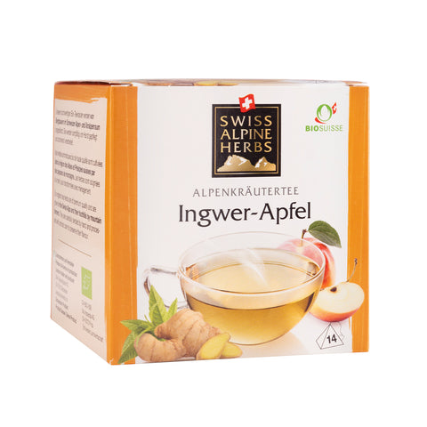 Packung mit Ingwer-Apfel-Alpenkräutertee von Swiss Alpine Herbs mit Teetasse, Ingwerwurzel und Apfelstücken