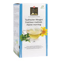 Verpackung von Swiss Alpine Herbs Alpenkräutertee mit Teetasse, Minzblättern und gelber Blume