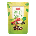 Verpackung mit dem Aufdruck 'nectaflor SWEET & SALTY NEW' und Abbildungen von Apfel, Mandeln, Cranberries und Kürbiskernen