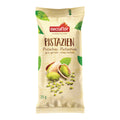 Verpackung von Nectaflor Pistazien, grün und gehackt (25 g). Schlanke beige Verpackung mit Abbildung von geöffneten Pistazien und gehackten Pistazienstücken. Produkt für Backen, Kochen oder als Topping geeignet.