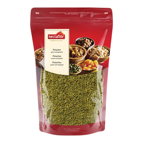 Rote Verpackung mit durchsichtigem Fenster, das gehackte grüne Pistazien zeigt, mit dem Markenlogo nectaflor und mehrsprachiger Produktbeschreibung