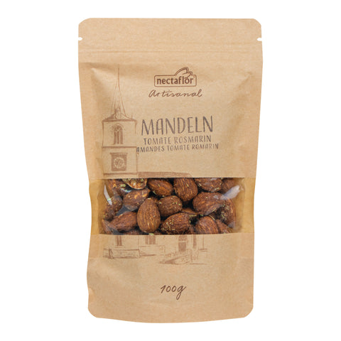 Braune Verpackung mit transparentem Sichtfenster, darin Mandeln, Aufdruck mit Turmzeichnung und Text 'nectaflor Artisanal MANDELN TOMATE ROSMARIN AMANDES TOMATE ROMARIN 100g'