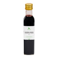Flasche mit goldfarbenem Schraubverschluss und weißem Etikett mit der Aufschrift 'CHIRSI-ESSIG VINAIGRE DE CERISE 25 cl'