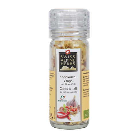 Transparenter Gewürzstreuer mit Etikett 'Swiss Alpine Herbs Knoblauch-Chips mit Alpen-Chili' und Abbildung von Knoblauch und Chili