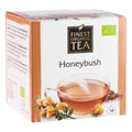 Verpackung des Honeybush-Tees von Finest Organic Tea. Weiße Teeschachtel mit beigefarbenen Akzenten, Abbildung einer Tasse Honeybush-Tee, Honeybush-Blüten und 14 Teebeuteln.