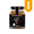 Glas mit Manuka-Honig der Marke Knopf Honey mit schwarzem Etikett und goldener Schrift, 250 Gramm